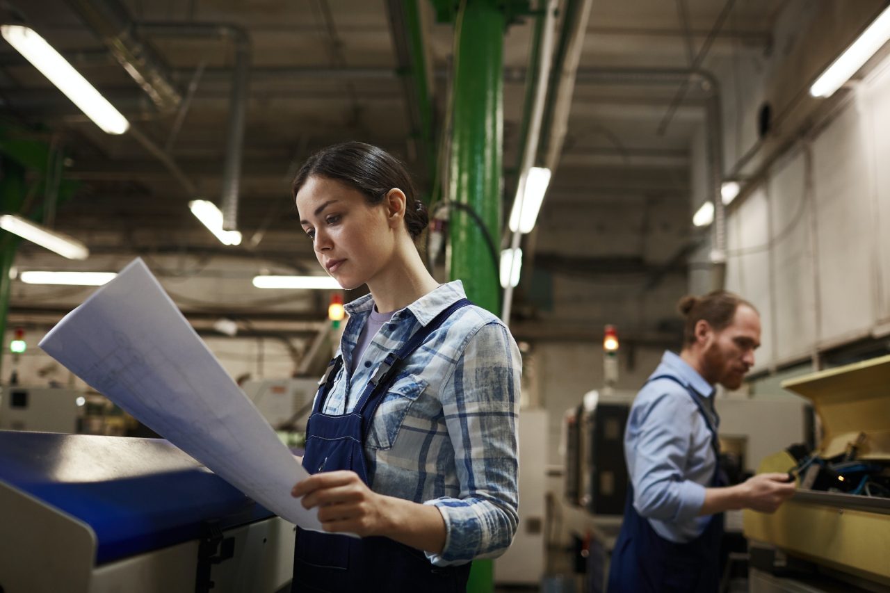 engineer with blueprint in indiana looking at industrial solutions for the factory