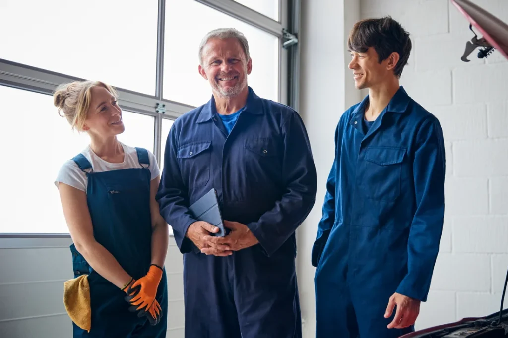 team of mechanics discussing hydraulic repair solutions with Am General