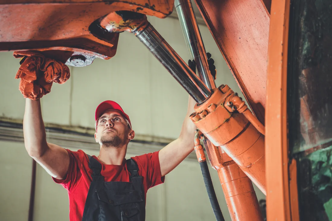 Mechanic performing hydraulic repair in an Indiana facility